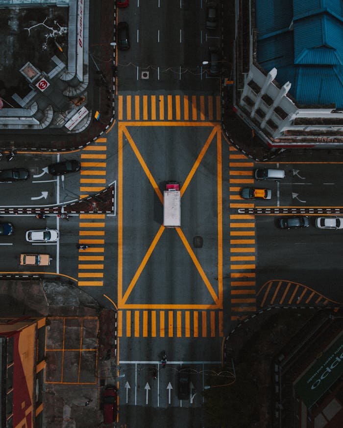 High-angle aerial view of a busy intersection in Ipoh, Malaysia, showcasing urban road layout.