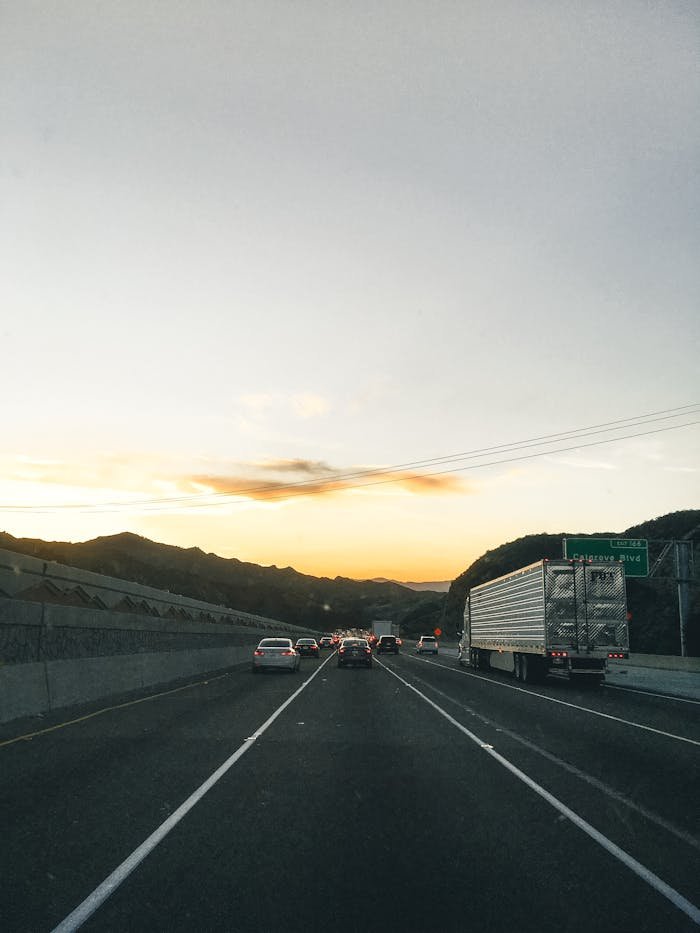 Traffic flows smoothly on a Los Angeles highway at sunset, showcasing the serene landscape.